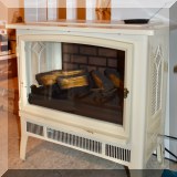 Z04. Duraflame electric fireplace heater with ivory case.